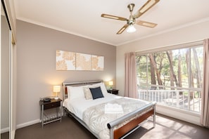 Parkview North's Bedroom Two: Queen bed, ceiling fan, inviting comfort for a serene stay.