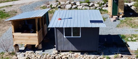 Tiny Cabin adjacent to outdoor kitchen, shower, dining, outhouse and parking.