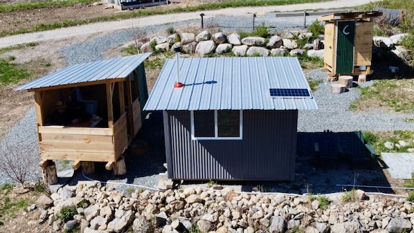 Tiny Cabin adjacent to outdoor kitchen, shower, dining, outhouse and parking.