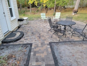 Enjoy the outdoor patio, complete with dining table and grill