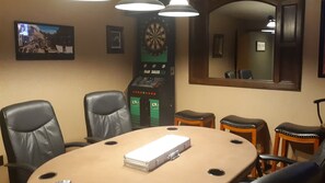 Poker room with poker table, full size dart board, tv and Boss Toss.