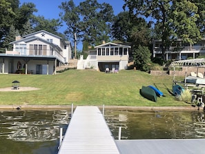 The home, covered patio on lower level and entrance to walk out bar.
