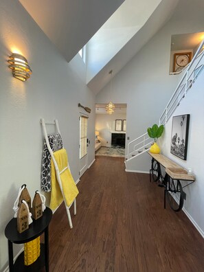 Front entry hallway looking into formal living room with fireplace