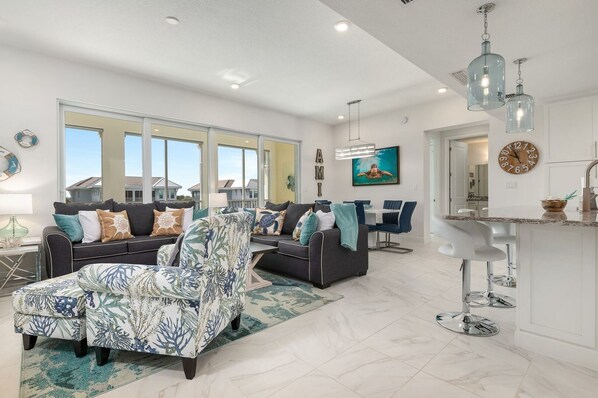 Brand new, open, spacious and comfortable living area offering plenty of seating and a 65" smart TV.  A wall of sliding doors open the space to the private lanai.