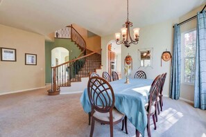 Dining room with spiral staircase behind