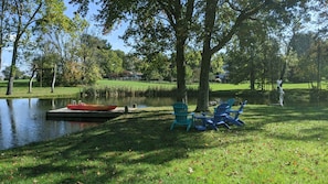 Adirondack chairs and swing by the dock