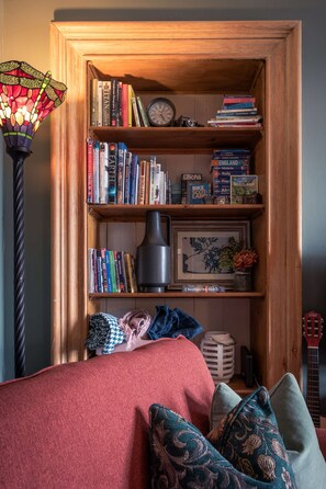 Cosy Living Room with comfortable seating, smart TV with Sky, PlayStation, games, toys and books