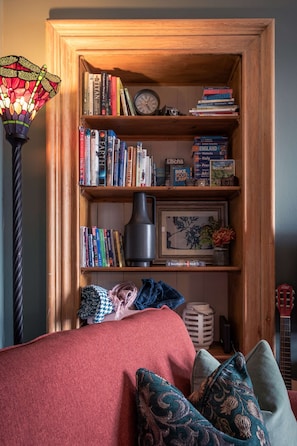 Cosy Living Room with comfortable seating, smart TV with Sky, PlayStation, games, toys and books