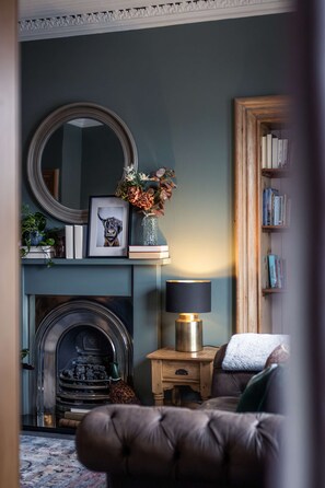 Cosy Living Room with comfortable seating, smart TV with Sky, PlayStation, games, toys and books