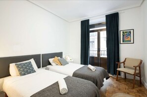 Bedroom with two single beds and balcony