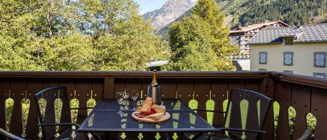 Balcony off the lounge with furniture and mountain views