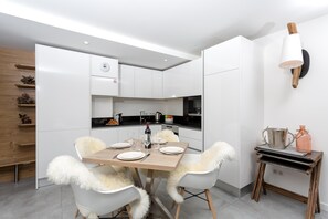 Modern, fully-equipped kitchen and dining table seats 4