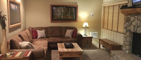 Spacious living room with Roku TV, cable TV, and gas fireplace 