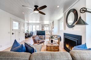 The second level living room includes a sofa and two accompanying arm chairs, for a cozy place to unwind at the end of the day.
                