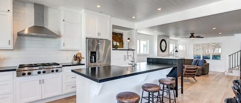 The second-level kitchen includes a spacious island with bar stools, making meal prep a social affair!