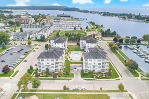 Aerial View of Complex - Aerial view of complex showing the Marina and Pere Marquette Lake. This condo is located in the building in the upper right corner of the complex along the marina and offers beautiful westerly views of the Marina and Lake Michigan Harbor