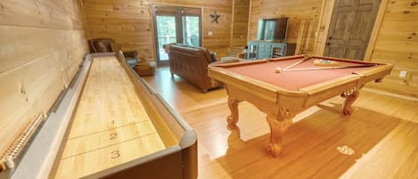 Game room with pool table, shuffle board, arcade games, and 50" smart tv