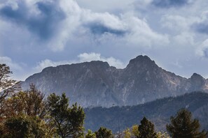 A stunning view of the mountains under a clear blue sky, capturing the beauty of the surroundings.