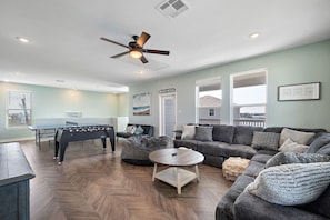 The second living room / Game Room with ping pong table, foosball, 65 inch TV and huge sectional!