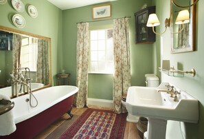 First floor: En-suite to bedroom two with a roll-top bath