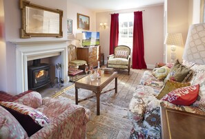 Ground floor: Spacious sitting room with wood burning stove