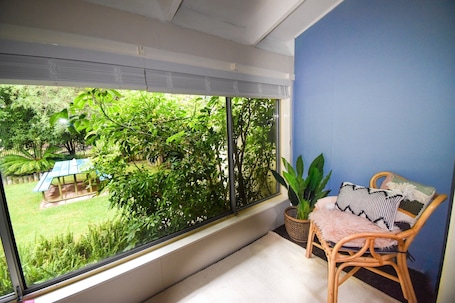 The Reading Nook in the King Suite outlooks the lush backyard and national park