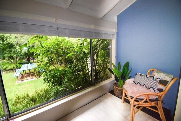 The Reading Nook in the King Suite outlooks the lush backyard and national park 