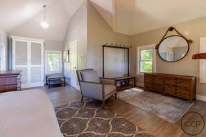 Modern decor. Armoire, dressers, a hook to hang your jacket and comfy chair.