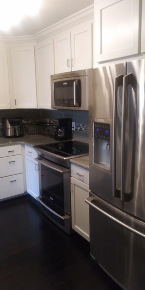 New stainless steel appliances and custom kitchen