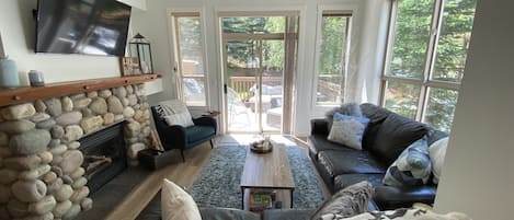 Spacious and bright living room looking out onto the walkout deck.