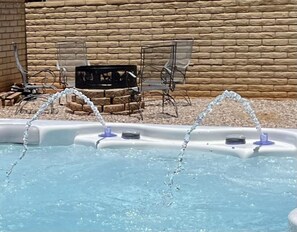 Hot Tub with fire pit in background 