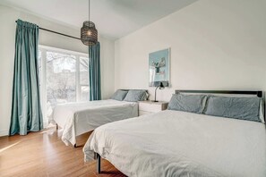 Bedroom 1 with 2 double beds & a large window overlooking famous Blvd. St. Laurent