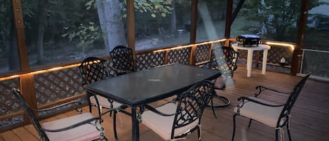 Large screened in covered deck with 2 ceiling fans
