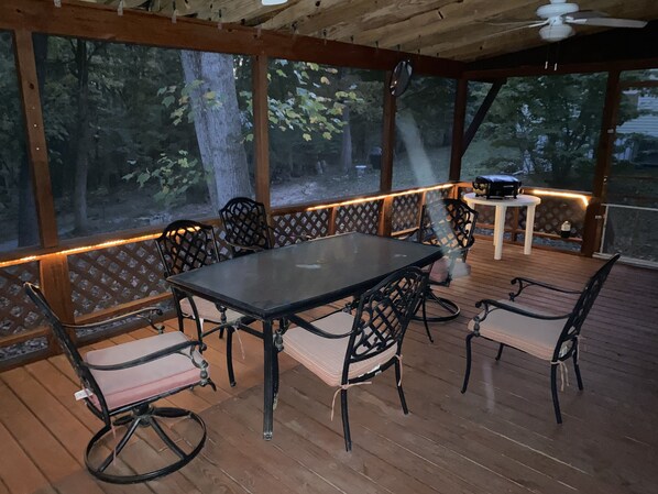 Large screened in covered deck with 2 ceiling fans