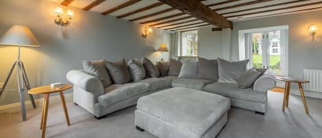 Barn Cottage, Salthouse: Sitting room with beams, stunning views of the marshes to the front and double doors to the rear garden