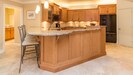 Another view of the kitchen with large refrigerator