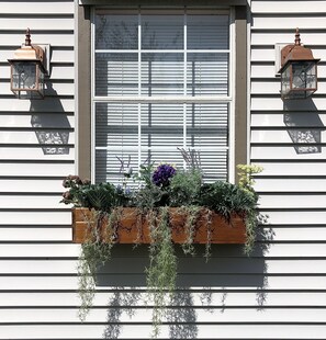 The custom cedar window box adds a cozy cottage vibe.