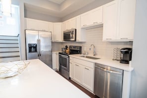 Our bright and white kitchen! You can see here the stairs that lead to our landing with our front balcony.