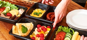 An image displaying a selection of delicious breakfast dishes, accompanied by a promotional text about discounts.
