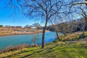 Camp Blanco has manicured, park like land on the lower level of the property along the Blanco River.