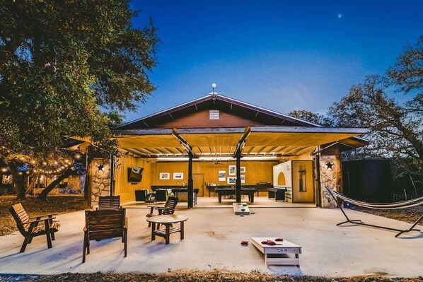 The Kookaburra ready for some fun with patio chairs, firepit, and hammock pulled outside and the pool table, poker table, shuffleboard, foosball, and darts inside.