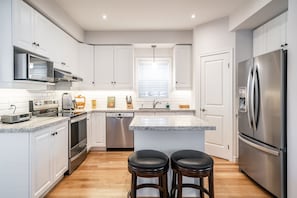 Large bright kitchen with granite counters