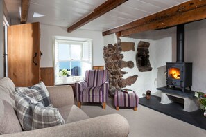 Trevarrow Cottage, Coverack. Ground floor: Get comfy in front of a wood burning stove