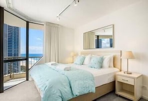 Comfortable king bed with ocean & city views  