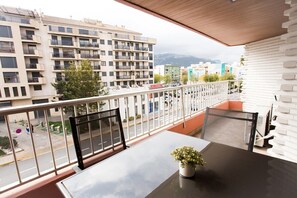 Large balcony with dining table and views to the mountains