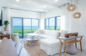 View from the bar out towards the living room and the Ocean. 