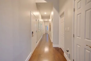 The hallway where the bedrooms and bathrooms are located.