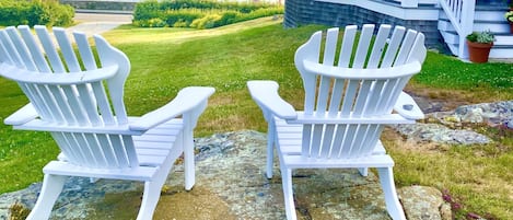 2 of the 4 Adirondack chairs facing ocean