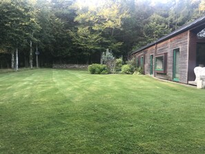 West side of house - showing spacious lawn at the edge of the woods