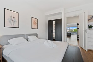 Elegantly simple bedroom with ample storage and natural light.